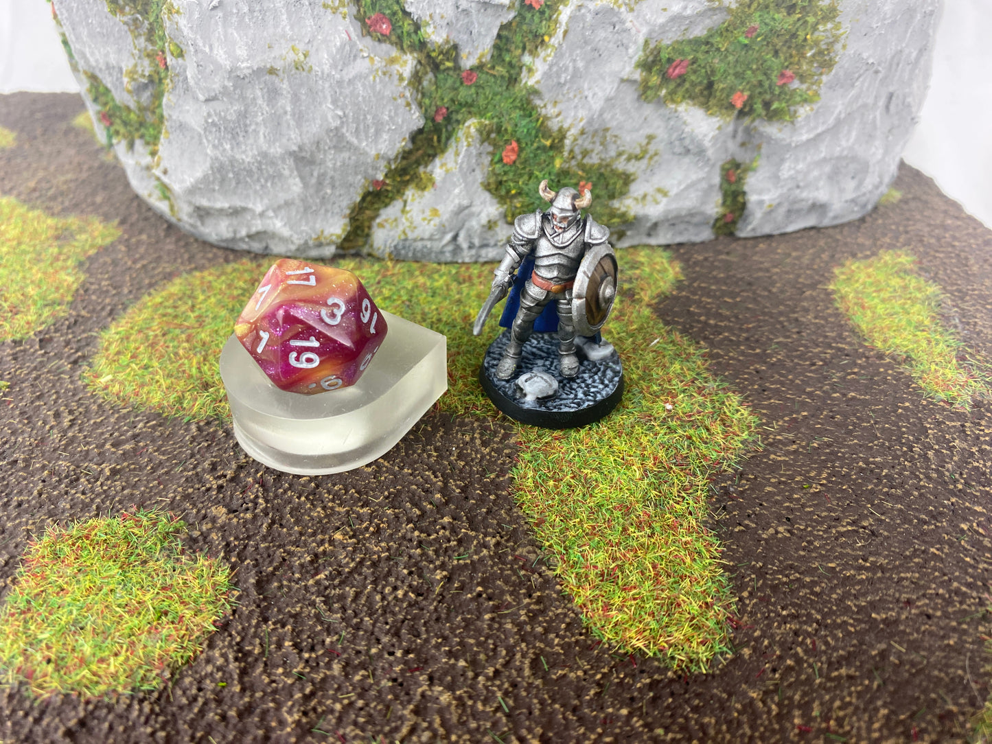 Die holder on the tabletop field with an die and a figure